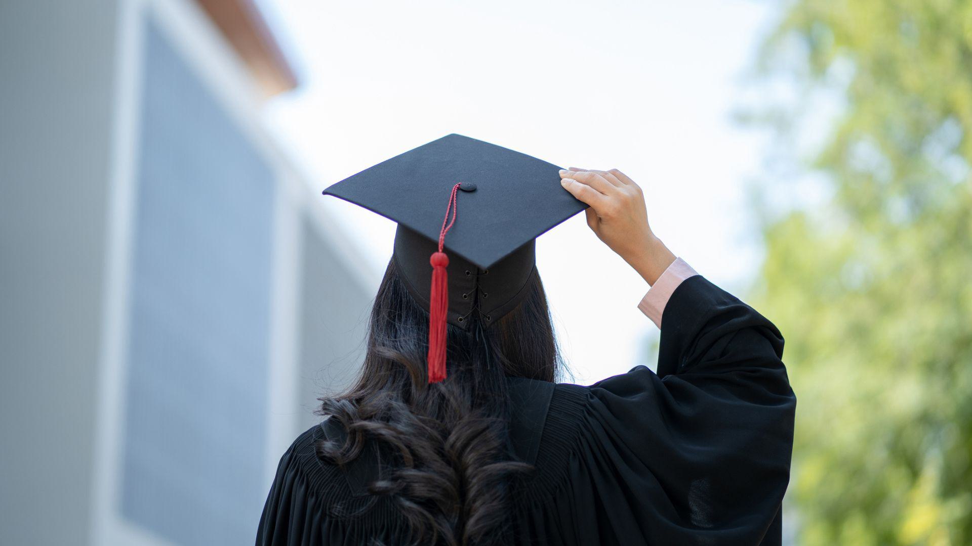 Woman in traditional graduation cap and gown