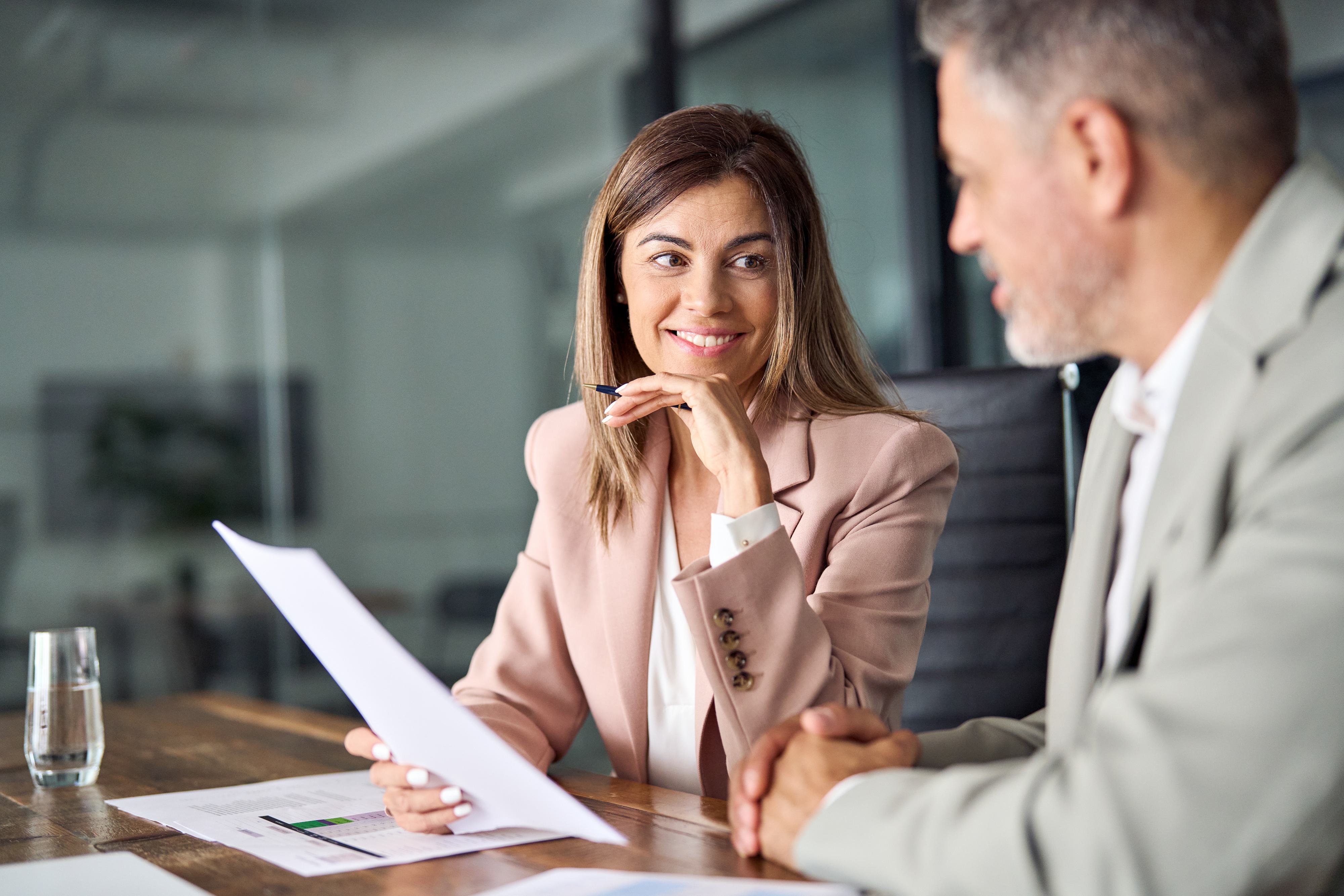 Business Woman and Business Man Looking at a Document