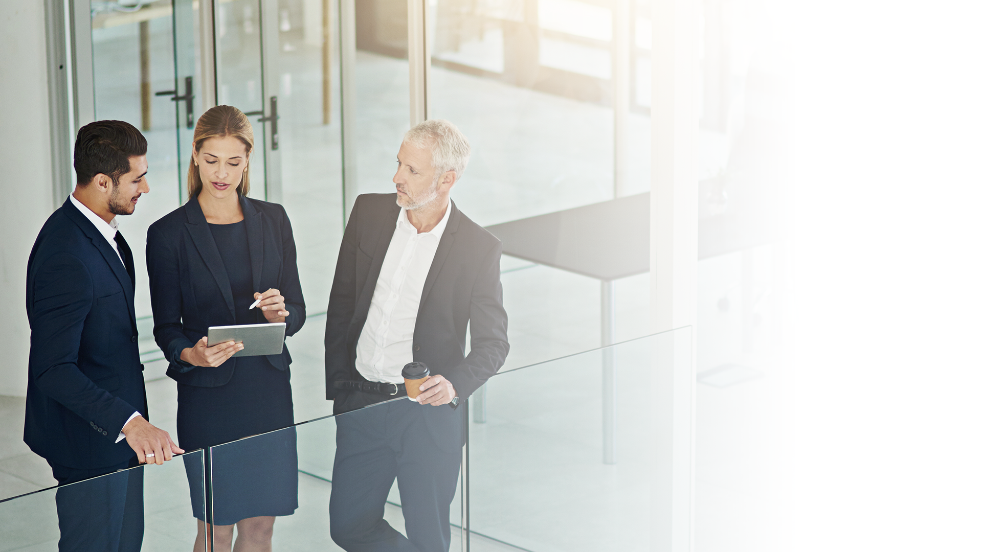 gourp of business professionals have a meeting in a hallway