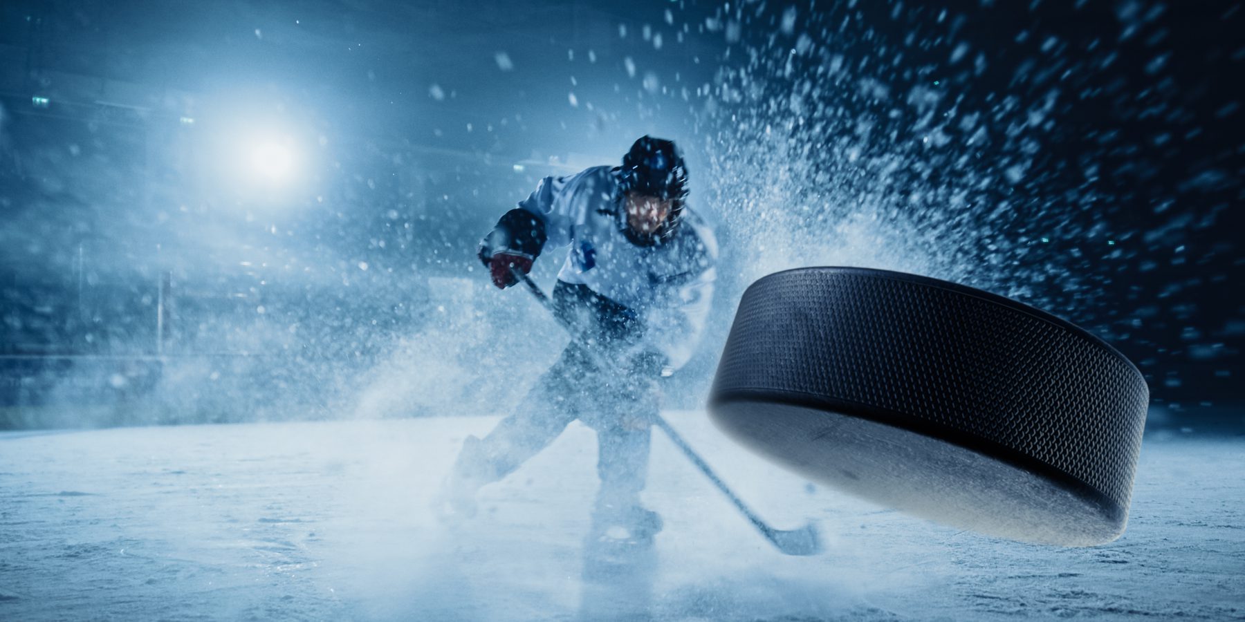 Hockey Player Shooting a Puck into the Camera